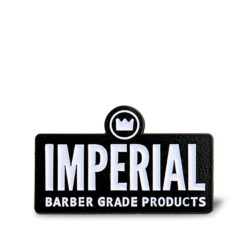 Imperial Barber Grade Products enamel pin with white lettering and crown icon on a black rectangular badge.