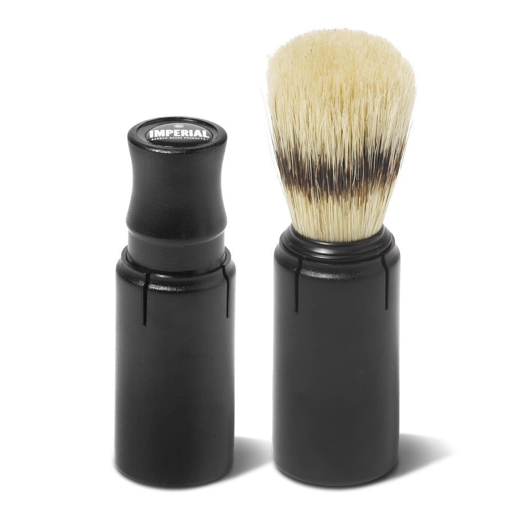 Imperial Barber Grade Products Travel Shave Brush shown assembled with bristles extended beside its black protective travel case.