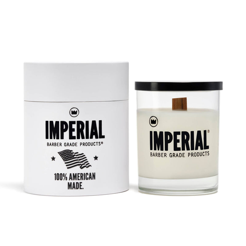Imperial Barber Grade Products scented candle in a clear glass with a wood wick, shown beside its white cylindrical gift box marked 100% American Made.