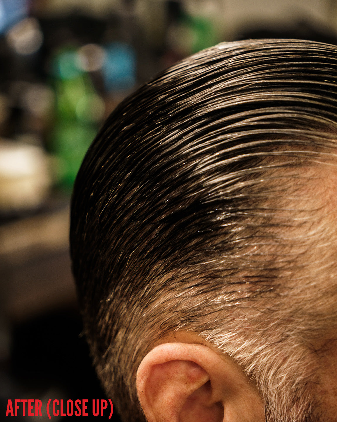 Close-up overhead view of dark hair combed back with a slick, low-shine finish after applying Imperial Blacktop Pomade.