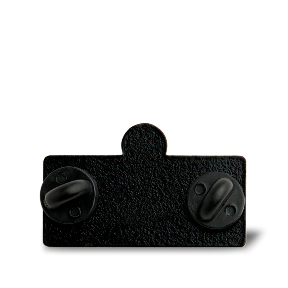 Back view of an enamel pin showing two rubber clutch fasteners on a black textured metal backing.