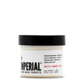 Front view of the Imperial Matte Pomade Paste 2 oz travel-size tub with black lid, showing light-to-medium hold, no-shine finish label.